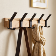 Close-up of the Nordic Coat Rack wood rail and hooks