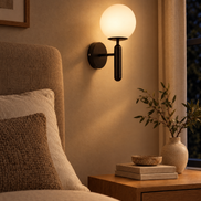 Selene Glass Globe Wall Sconce switched on at night