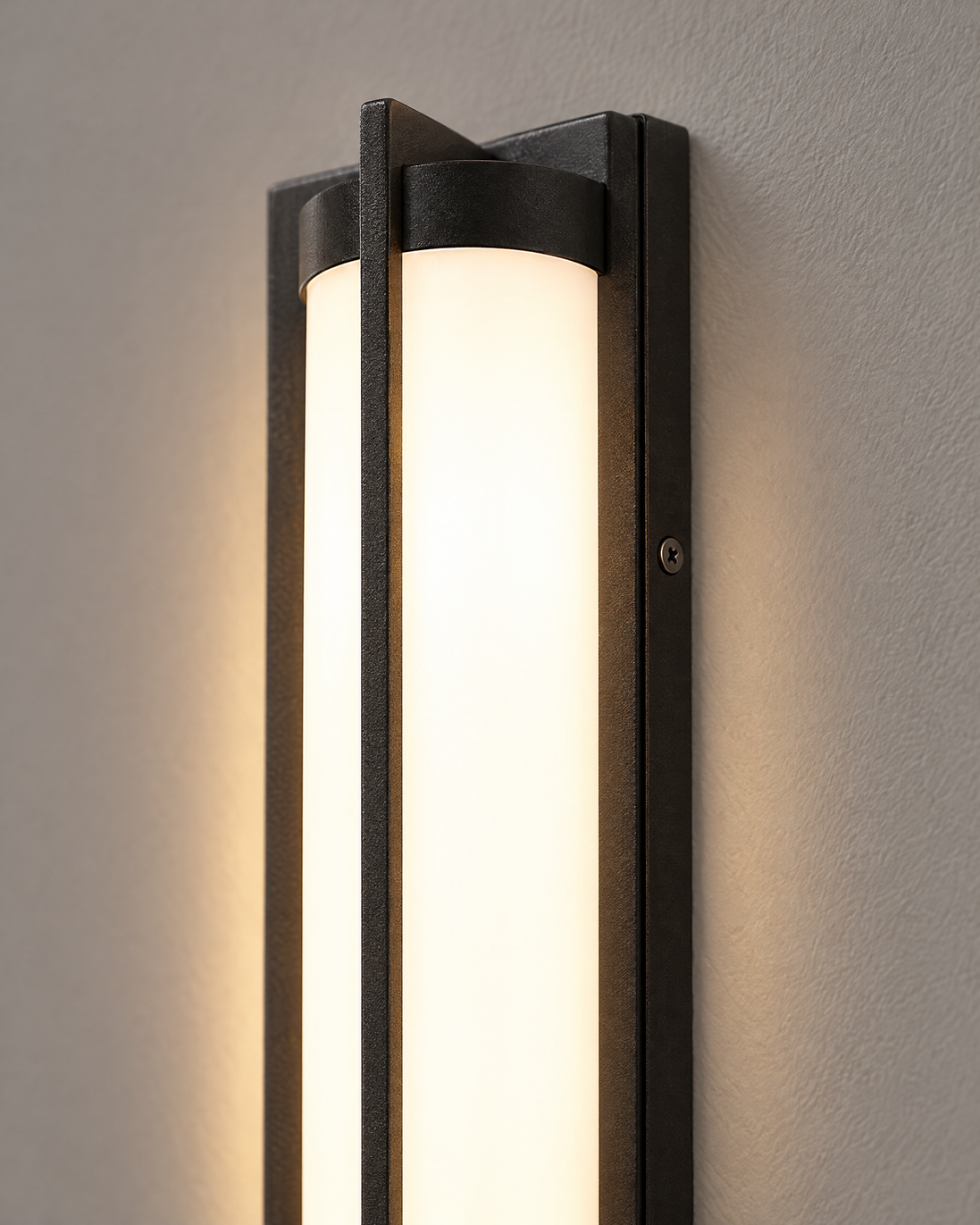 Close-up of the Nerolo sand-black frame and glowing white diffuser