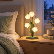 Muguet flower lamp glowing on a bedside table in a cozy bedroom