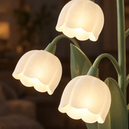 Close-up of the frosted bell shades glowing on the Muguet lamp