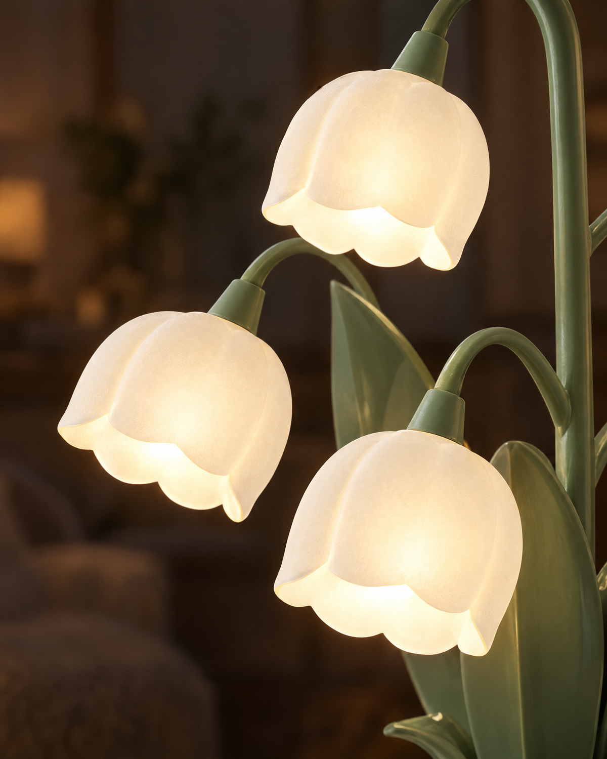 Close-up of the frosted bell shades glowing on the Muguet lamp