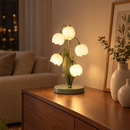 Muguet lily of the valley lamp on a walnut sideboard in a living room at night