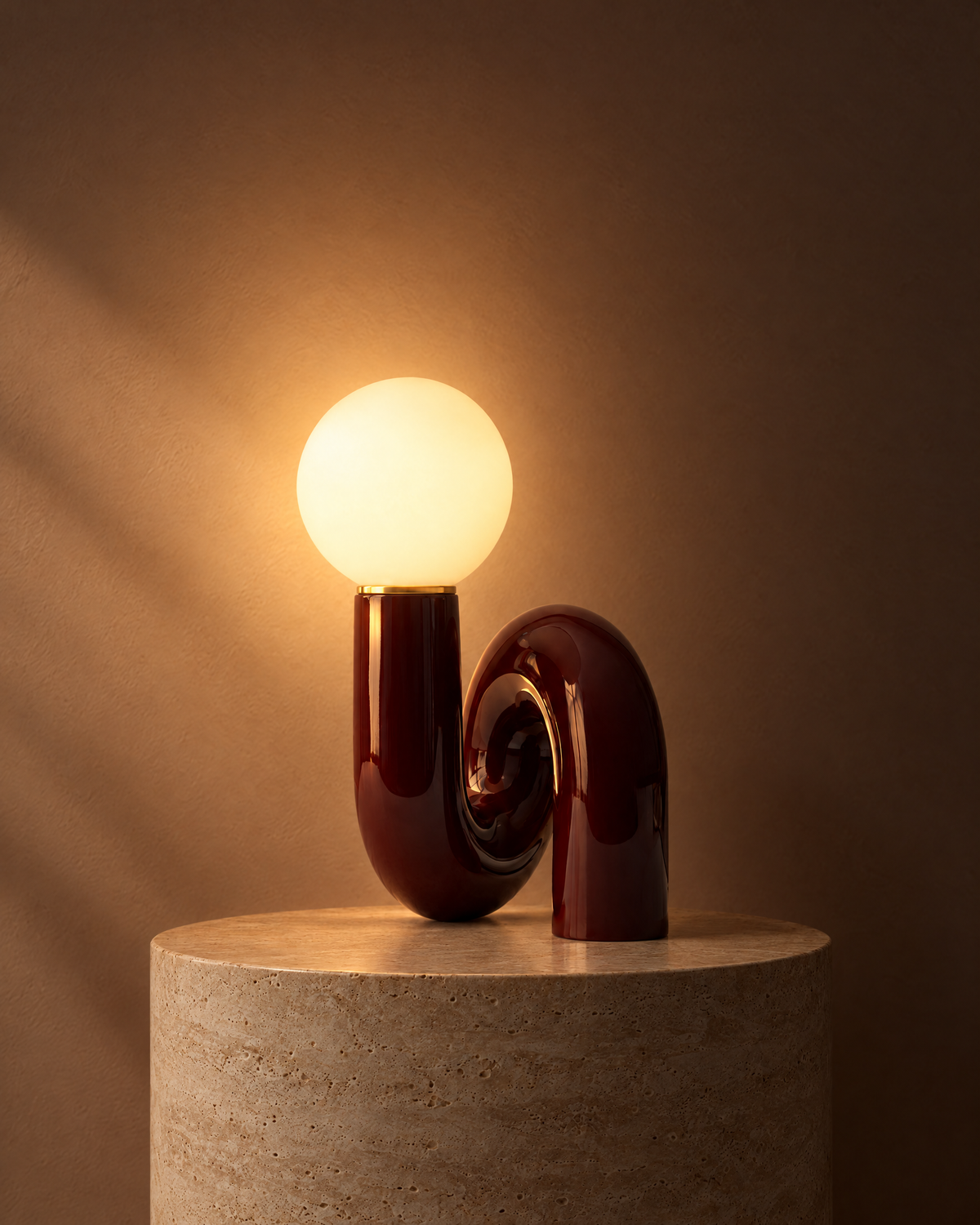 Swirl globe table lamp in dark red switched on, globe glowing warm