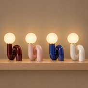 Swirl globe table lamp in dark red, pink, blue and white on a shelf