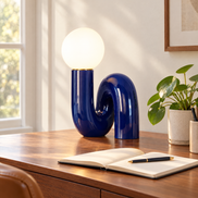 Blue swirl globe table lamp on a walnut desk in a home office