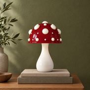 Toadstool mushroom lamp with a red dotted cap and white stem, switched off